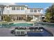 Backyard oasis showcasing a sparkling pool and spa, set against a backdrop of mature landscaping and a covered patio at 2338 Dolphin Ct, Henderson, NV 89074