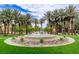 Beautifully landscaped community area featuring a large decorative fountain surrounded by lush greenery at 2338 Dolphin Ct, Henderson, NV 89074