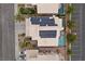 Aerial view of a home featuring a swimming pool, well maintained landscape and solar panels on the roof at 283 Grand Olympia Dr, Henderson, NV 89012