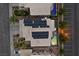 Aerial view of property featuring solar panels, a swimming pool and well-maintained backyard at 283 Grand Olympia Dr, Henderson, NV 89012