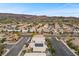 Wide aerial perspective of community showcasing diverse homes and the mountain backdrop at 283 Grand Olympia Dr, Henderson, NV 89012