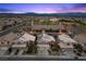 An aerial shot of residences, including a church and community park with mountain views in the background at 283 Grand Olympia Dr, Henderson, NV 89012