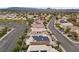 Community aerial showing houses with solar panels, desert landscaping, mountain views and parking at 283 Grand Olympia Dr, Henderson, NV 89012