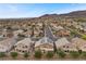 An aerial shot of neighborhood residences, many featuring solar panels, with mountain views in the background at 283 Grand Olympia Dr, Henderson, NV 89012