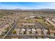 Wide aerial view of a residential neighborhood with desert landscaping and community recreation areas at 283 Grand Olympia Dr, Henderson, NV 89012