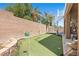 Backyard featuring a putting green, spiral staircase, and covered patio for entertainment and relaxation at 283 Grand Olympia Dr, Henderson, NV 89012