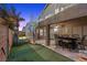 Backyard with putting green, patio, spiral staircase and a partially visible pool at 283 Grand Olympia Dr, Henderson, NV 89012