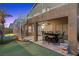 A lush backyard featuring a patio, putting green, swimming pool, and spiral staircase at 283 Grand Olympia Dr, Henderson, NV 89012
