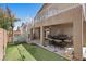 Well-maintained backyard featuring a putting green, a spiral staircase, and a covered patio area at 283 Grand Olympia Dr, Henderson, NV 89012