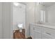 Bathroom with white vanity and marble countertop, plus wood-look flooring at 283 Grand Olympia Dr, Henderson, NV 89012