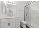 Modern bathroom featuring a glass shower, updated vanity, and white color palette at 283 Grand Olympia Dr, Henderson, NV 89012