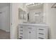 Bathroom vanity with marble countertop and white cabinets, plus large frameless mirror at 283 Grand Olympia Dr, Henderson, NV 89012