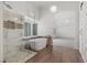 Modern bathroom features a soaking tub, glass shower, and wood-look tile flooring at 283 Grand Olympia Dr, Henderson, NV 89012