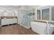 Elegant bathroom with double vanity, standalone tub, and frameless glass shower at 283 Grand Olympia Dr, Henderson, NV 89012