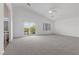 Spacious primary bedroom featuring a vaulted ceiling, ceiling fan, and access to a private balcony at 283 Grand Olympia Dr, Henderson, NV 89012