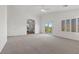 Bright primary bedroom offers plush carpet, fan and access to bathroom at 283 Grand Olympia Dr, Henderson, NV 89012