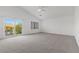 Spacious primary bedroom featuring a vaulted ceiling, ceiling fan, and access to a private balcony at 283 Grand Olympia Dr, Henderson, NV 89012