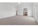 Bright primary bedroom offers plush carpet, fan and access to bathroom at 283 Grand Olympia Dr, Henderson, NV 89012