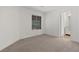 Empty bedroom with neutral carpet, window, and trim at 283 Grand Olympia Dr, Henderson, NV 89012