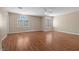Primary bedroom with wood flooring, ceiling fan, and shuttered windows at 283 Grand Olympia Dr, Henderson, NV 89012