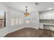 Sunlit dining area with plantation shutters and designer lighting fixture near the kitchen at 283 Grand Olympia Dr, Henderson, NV 89012