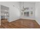 Open-concept dining area with hard wood floors, vaulted ceilings, and large windows that allow ample natural light at 283 Grand Olympia Dr, Henderson, NV 89012