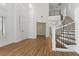 Open entryway with wood-look floors and wrought iron staircase at 283 Grand Olympia Dr, Henderson, NV 89012