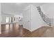 Inviting entryway showcases hardwood floors, white walls, staircase, and a view to the open concept living space at 283 Grand Olympia Dr, Henderson, NV 89012