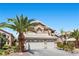 Two-story home with a two-car garage and desert landscaping at 283 Grand Olympia Dr, Henderson, NV 89012