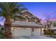 Charming two-story home featuring a three-car garage and meticulous landscaping at 283 Grand Olympia Dr, Henderson, NV 89012