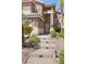 Entrance with stone steps and desert landscaping at 283 Grand Olympia Dr, Henderson, NV 89012