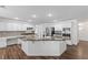 Spacious kitchen features white cabinetry, granite countertops, stainless steel appliances, and a large central island at 283 Grand Olympia Dr, Henderson, NV 89012
