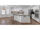 Well-equipped kitchen with white cabinetry, stainless steel appliances, granite countertops, and convenient breakfast bar at 283 Grand Olympia Dr, Henderson, NV 89012