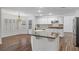 Bright kitchen with white cabinets, stainless steel appliances, granite countertops, and an adjacent dining area at 283 Grand Olympia Dr, Henderson, NV 89012