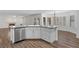 Kitchen island with stainless steel dishwasher, ample storage, and granite countertop overlooking the dining area at 283 Grand Olympia Dr, Henderson, NV 89012