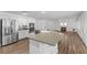 Open kitchen boasts stainless steel appliances and granite countertops, flowing into an airy living space with fireplace at 283 Grand Olympia Dr, Henderson, NV 89012