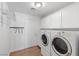 Functional laundry room with modern washer/dryer and ample storage at 283 Grand Olympia Dr, Henderson, NV 89012