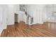 Spacious living room with wood-look floors and wrought iron staircase at 283 Grand Olympia Dr, Henderson, NV 89012