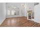 Open living room with wood-look floors and bright natural light at 283 Grand Olympia Dr, Henderson, NV 89012