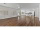 Open-concept living room flows seamlessly into the kitchen, offering wood floors, and shuttered windows throughout at 283 Grand Olympia Dr, Henderson, NV 89012