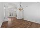 Bright living room with hardwood floors, decorative columns, and a modern light fixture creating an inviting space at 283 Grand Olympia Dr, Henderson, NV 89012