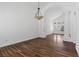 Inviting living room featuring wood floors, vaulted ceilings, decorative columns and a modern light fixture at 283 Grand Olympia Dr, Henderson, NV 89012