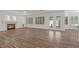 The spacious living room has wood floors, a fireplace, many windows with shutters, and access to the kitchen at 283 Grand Olympia Dr, Henderson, NV 89012