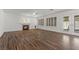 Cozy living room with a fireplace, wood floors, and French doors leading to the outdoor area, perfect for relaxation at 283 Grand Olympia Dr, Henderson, NV 89012