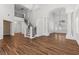 Spacious living room with wood-look floors and wrought iron staircase at 283 Grand Olympia Dr, Henderson, NV 89012