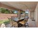 Covered patio with stylish dining set, perfect for outdoor entertaining and enjoying the serene backyard at 283 Grand Olympia Dr, Henderson, NV 89012