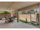 Spacious covered patio with a full dining set and stainless steel grill, perfect for backyard gatherings and barbecues at 283 Grand Olympia Dr, Henderson, NV 89012
