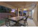 Charming covered patio features a sleek outdoor dining set, perfect for entertaining guests in style at 283 Grand Olympia Dr, Henderson, NV 89012