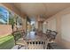 Covered patio featuring an outdoor dining set, ideal for al fresco meals and relaxation in the backyard at 283 Grand Olympia Dr, Henderson, NV 89012