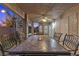 Elegant outdoor dining on the covered patio with a fire pit dining table and comfortable seating at 283 Grand Olympia Dr, Henderson, NV 89012